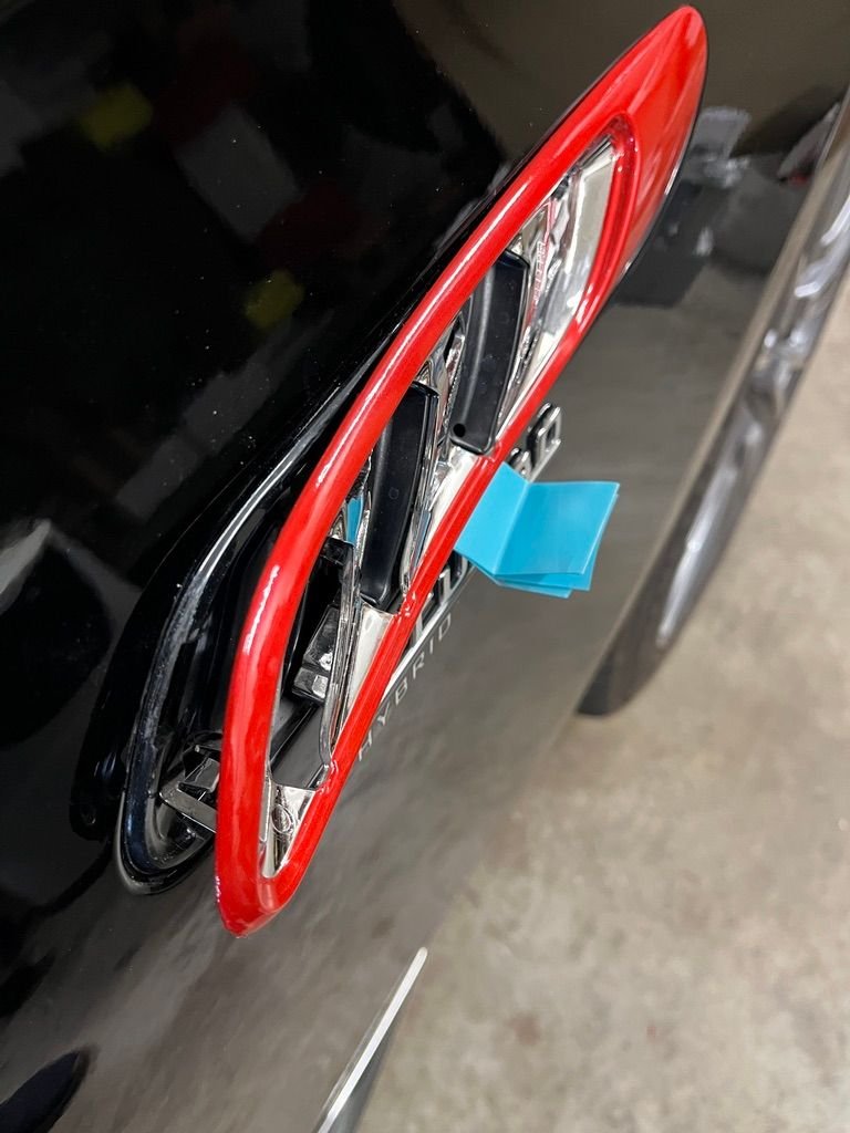 Rear edge of chrome trim pulled away from black base.