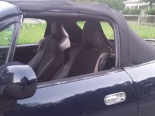 BRZ seats on stock miata rails with adapter clear the soft top.  glass rear window.