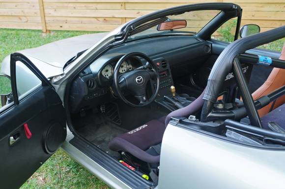 The interior finally is close to what I've imagined for years. I've added an IL Motorsports center console, Hard Dog roll bar wrap, a custom brass shift knob, and finished up the radio install.