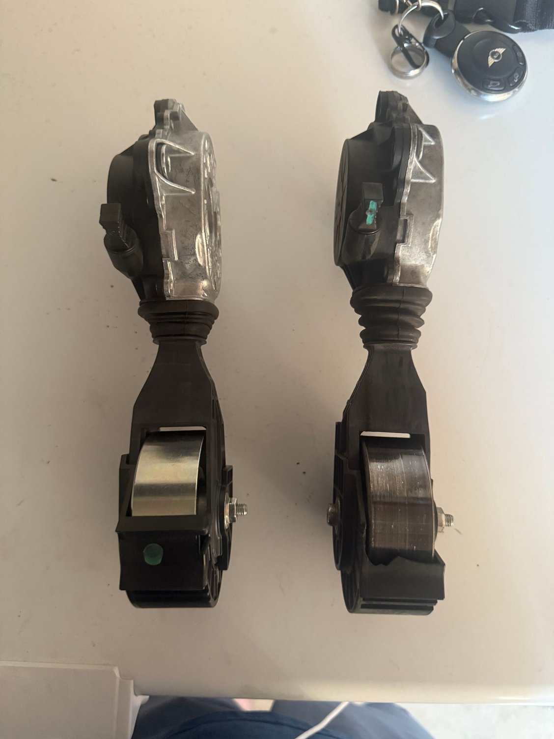Here�s the side view picture of the new one again versus the old one on the right side as a little damage to the plastic housing, which probably happened when my serpentine belt dry rotted and broke apart. 