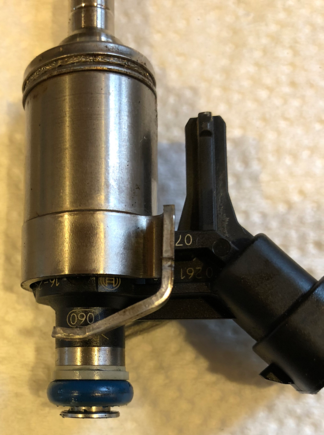 Close-up of removed injector showing rail-side sealing ring.