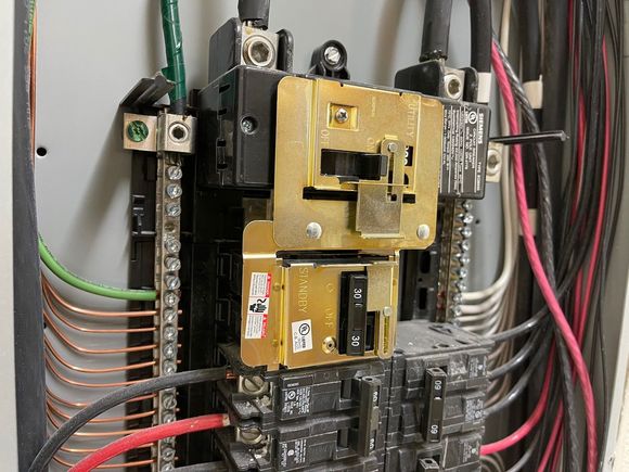 There are many side projects since I have the excavators and crew here. Here I install a generator lockout plate for the main house and retrofitting a feed from the generator thru the other main panel.