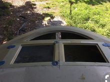 The plexiglass on the moon shape is fixed but the other two doors move out of the way and you can sit on the deck with your feet on the floor of the anchor locker somewhat secure in case you need to operate the winch from the bow