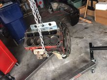 After you use a pry bar and pry the block off the trans. Mine was easy because if you read I just got the transmission redone. You can lift the block out. My truck has a 4/6" drop and I didn't have to take off the front end and used a harbor freight 1 ton shop crane.