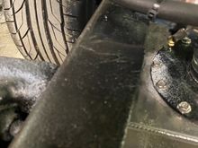 A little hard to see, ... but I sliced the top of the frame rail and bent it down to about 45 degrees, then plated it back in. This allows the fill hose to pass up between the frame and bed, without any issues.