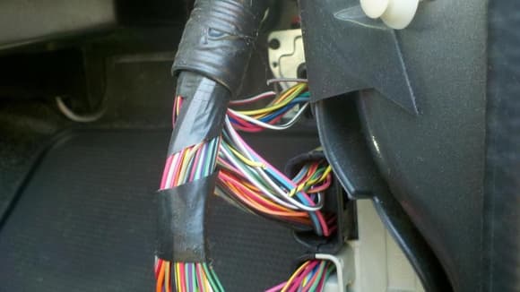 passenger side kick panel...snipped yellow/black wire to disable drivers door chime and light; red/gray for passenger side