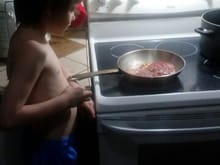 My little man cooking him and his momma a steak! 