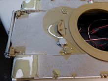 Shows the front mudflaps filled in since the A2 uses this type.  Hand hold replaced with wire.  Filler cap was re-oriented to an angle, handle replaced, retaining chain added, and details re-worked.  Mineplow connection box added.  Track hanger pins simulated.  Lip detail added to the driver's hatch.  Fender springs re-worked with metal rod and added track endlinks.