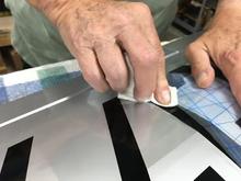 Here I am simultaneously peeling the transfer tape and wiping the "1" in the registration markings. One thing's for certain: I'll never be a hand model.