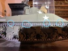 Above the tracks on the chassis or sponson. You have to remove the tracks and sneak a skinny screwdriver through the suspension.