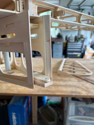 I started by putting balsa pieces to bridge very rear outsides.  Then you can see the lower hinge on a balsa wedge