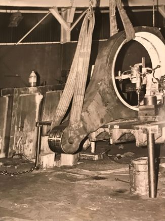 A little side shot from 1979, USI Clearing Detroit Service Center  Back  in the heavy machine repair, sweat shop days.
The iron link was heated with a ring burner for four hours.  The two bronze half bushings were packed in dry ice at the same time. We lowered the bronze into the housing on tongs hung below the crane. Four or five men with maple blocks and 5 pound rawhide hammers would drive the bushings home together very evenly. 
   You had one shot at it. Get it skewed and we were screwed.