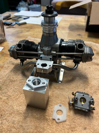 Here's the mount face of the venturi appearing out of the aluminum block.  You can also see the .200 polypropylene insulator I made.  This works great on my other Gemini.