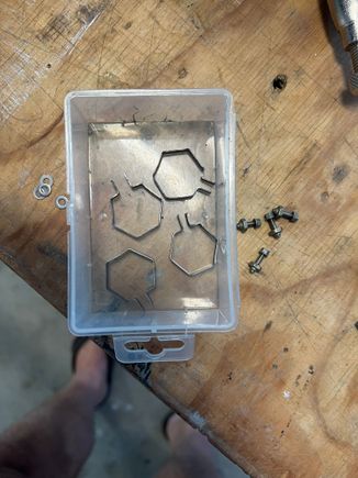 Mild steel straps.  Shape must be accurate or they will loosen in service.