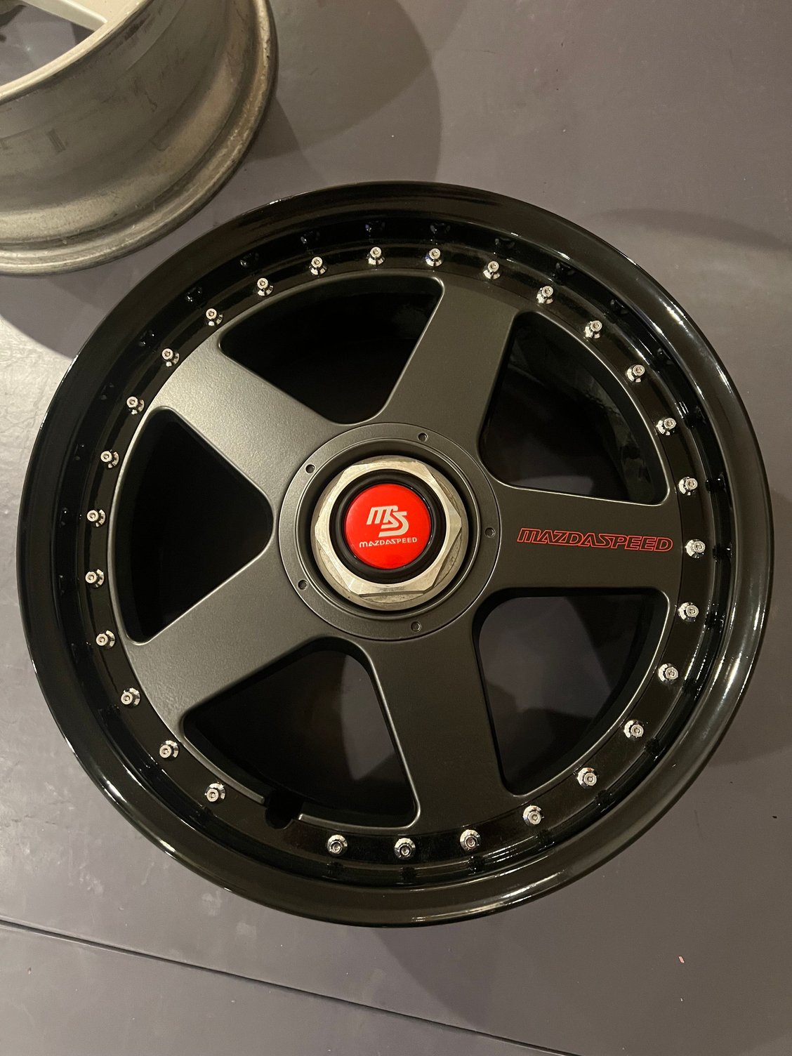 Chrome lettering in the center decal. Unfinished center nut. 