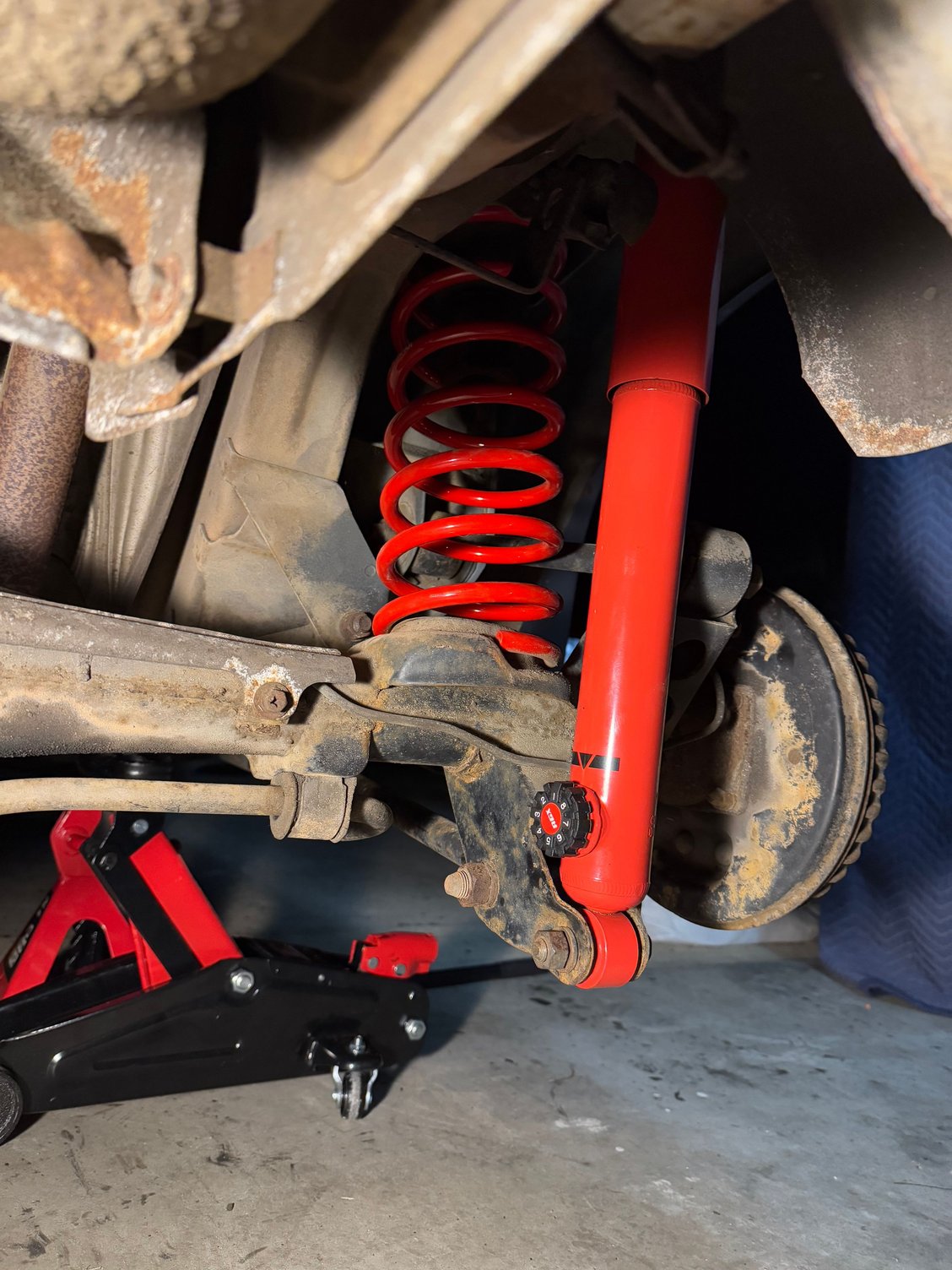 Remove the old shock at the locking bolts, from the top hatch area and replace with the new one. Bolt the mounting eye back up.