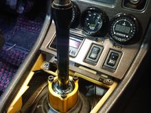 I enlarged the diameter of the OEM upper rubber boot to fit around the new shifter, seals well.  