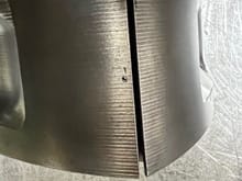 Ignore the chunk missing and notice the edges of the groove near the corner seal