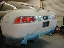 Integra tail lights with a chopped Buddy Club rear bumer for an Accord fitted
The gray corner flares you see are Veilside Rear under spoilers for a FD3
Notice I also had to fabricate pedestals for the wing