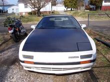 hood was painted black when I bought the car, repainted it as well as painting the headlight covers.  Would have preferred the stock white, but it would have been impossible to color-match the rest of the car :-( new paint job all-around soon to come.