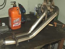 I built this stainless steel header and I am building a 1 inch thick spacer to extend the intake runners and I ported the stock intake manifold and modifyed the Nikki carb. All are for my 12A RX7.