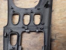 Underside view. All the mounting tabs/pins are intact, but one of the metal clips that goes on a tab is missing.