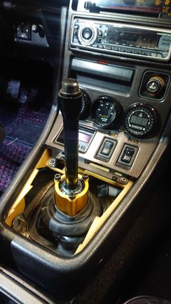 Enlarge the opening in OEM rubber boot, it fits snugly over the housing.  