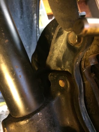 Remove the top bolt of the caliper mounting braket using a 14 mm socket.