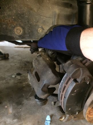 Pull the caliper from the top pin and remove the brake pads. Be sure not to let the caliper hang from the brake line.