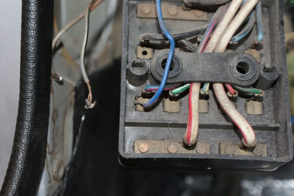 This is where the stray wire was popped into the fuse block.  The two gray wires to the left were speaker wires, now removed.