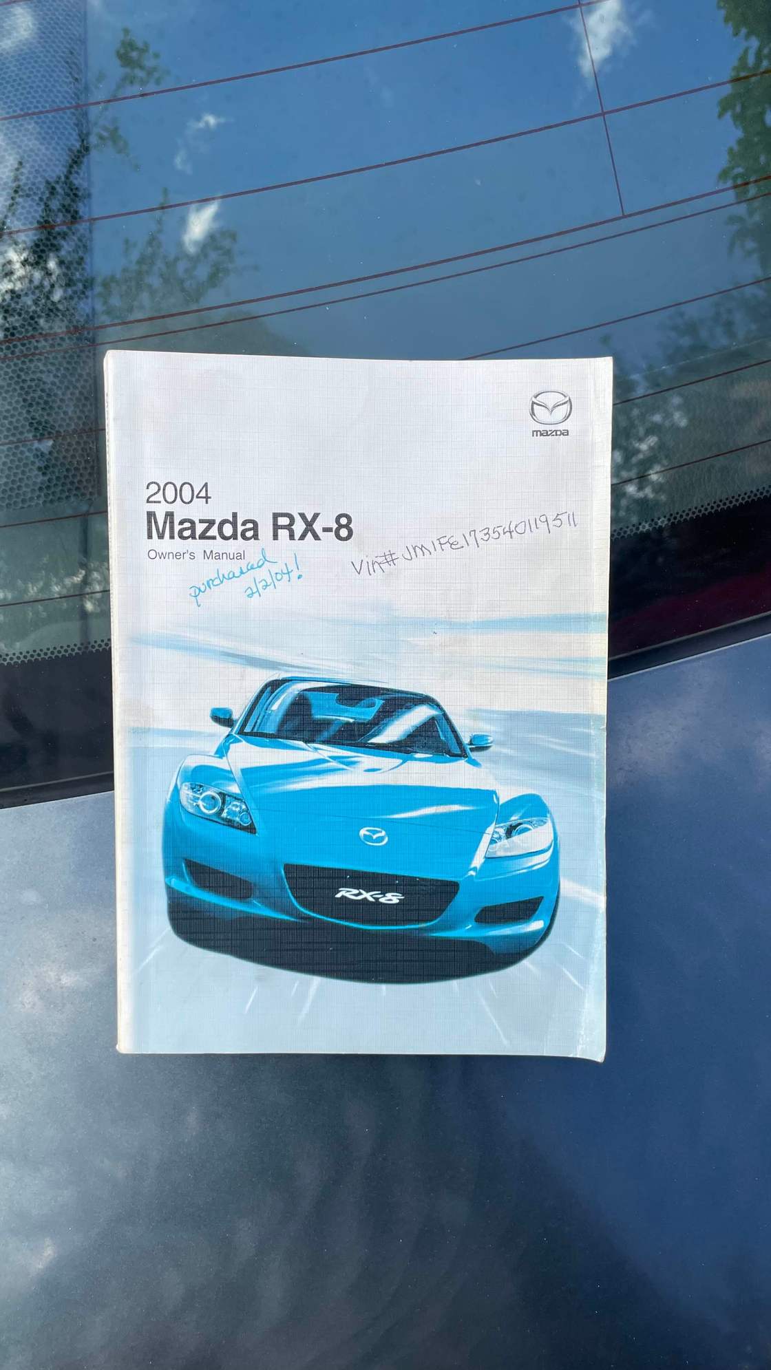 Picture of the manual with the VIN and original purchase date written on the cover.