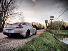 RX8 parked near stream, out in the country.  Photo taken near sunrise time - but you can still see the moon :)
