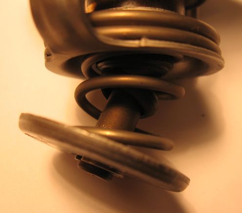 Thermostat removed from 2005 AT RX8. Metal failure. Car was not symptomatic while this was in operation. It was discovered during routine maintenance.