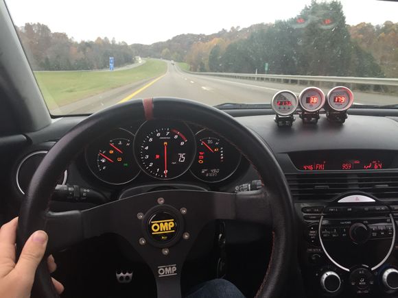 I actually enjoy this wheel more than the stocker. Look at all the lights on the dash though. Christmas came early in this bitch. Water temp, RPM, and Oil Pres on top the console. You can beleive me or not, but I got 34MPG on 93OCT taking this thing back home from TN and having a 250lb passenger and over 200lbs in the car of junk. With low PSI tires and a vaccum leak.