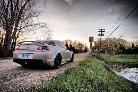RX8 parked near stream, out in the country.  Photo taken near sunrise time - but you can still see the moon :)