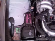 battery gone, coolant bottle moved and wires all tucked away. &quot;custom&quot; heat shield panel...haha