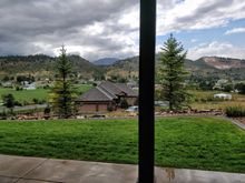 Looking out the basement great room to one grass area of the two, due west.  BTW, I went to that house below and made new friends.  The couple has two teenage boys and they will be great neighbors.