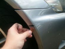 Scratch through paint on passenger side of bumper.