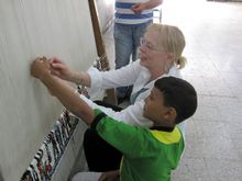 725 Two children weaving rugs.JPG
