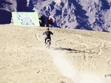 1307119572 biker jumps Off mountain