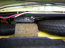 Spare tire area view with the amplifier for the sub