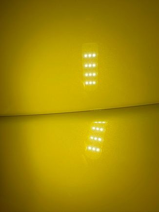 Top is the bumper, spoiler on the bottom. Taken under strong LED lighting. 