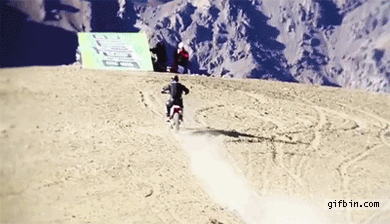 1307119572 biker jumps Off mountain
