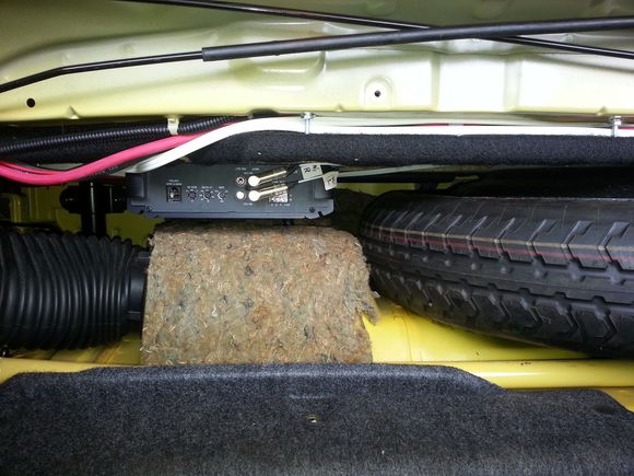 Spare tire area view with the amplifier for the sub