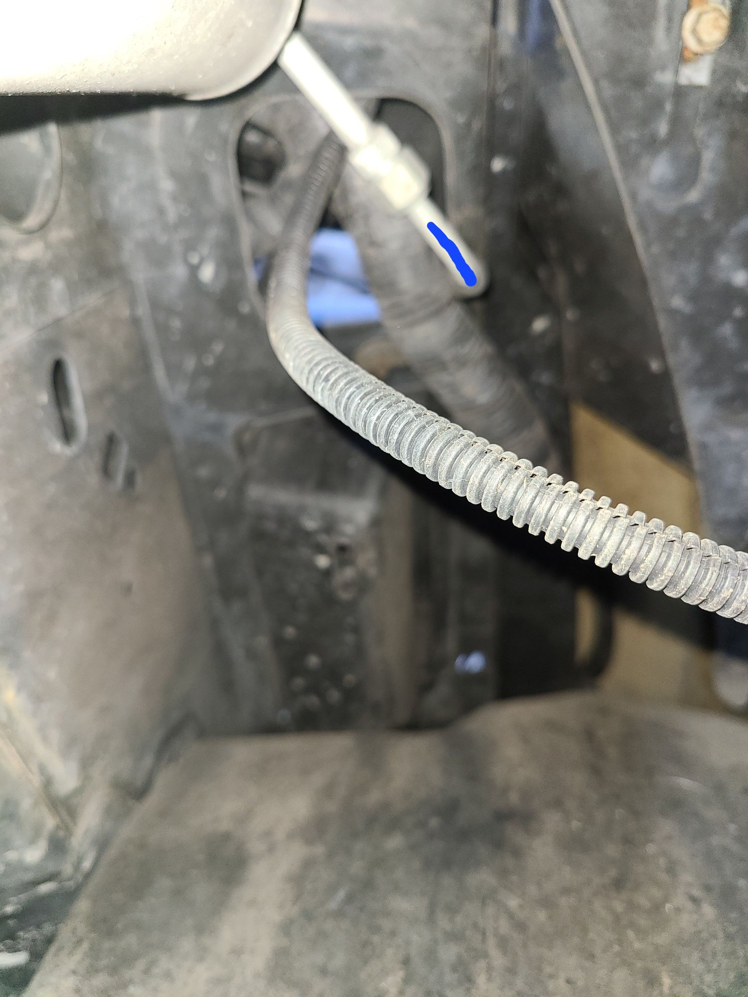 The liquid line, seen from below the receiver drier, begins at the receiver drier outlet fitting.