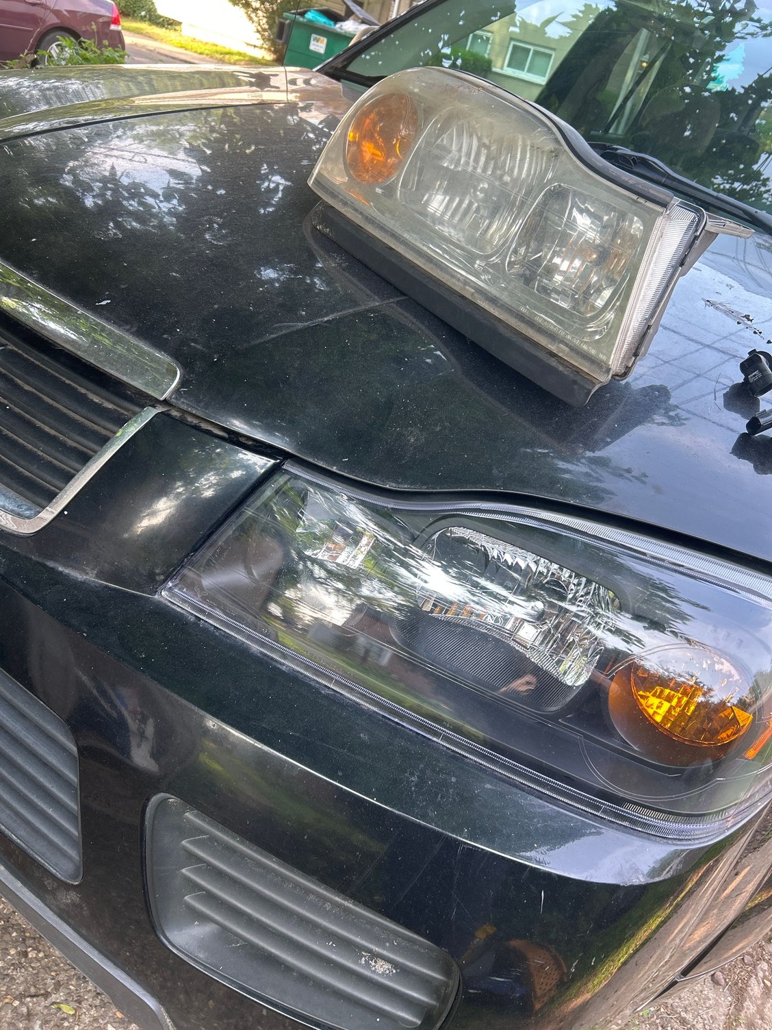 Old headlight is on hood , I replaced the whole piece with a new set of headlights for both sides (new ones I put in the car)
