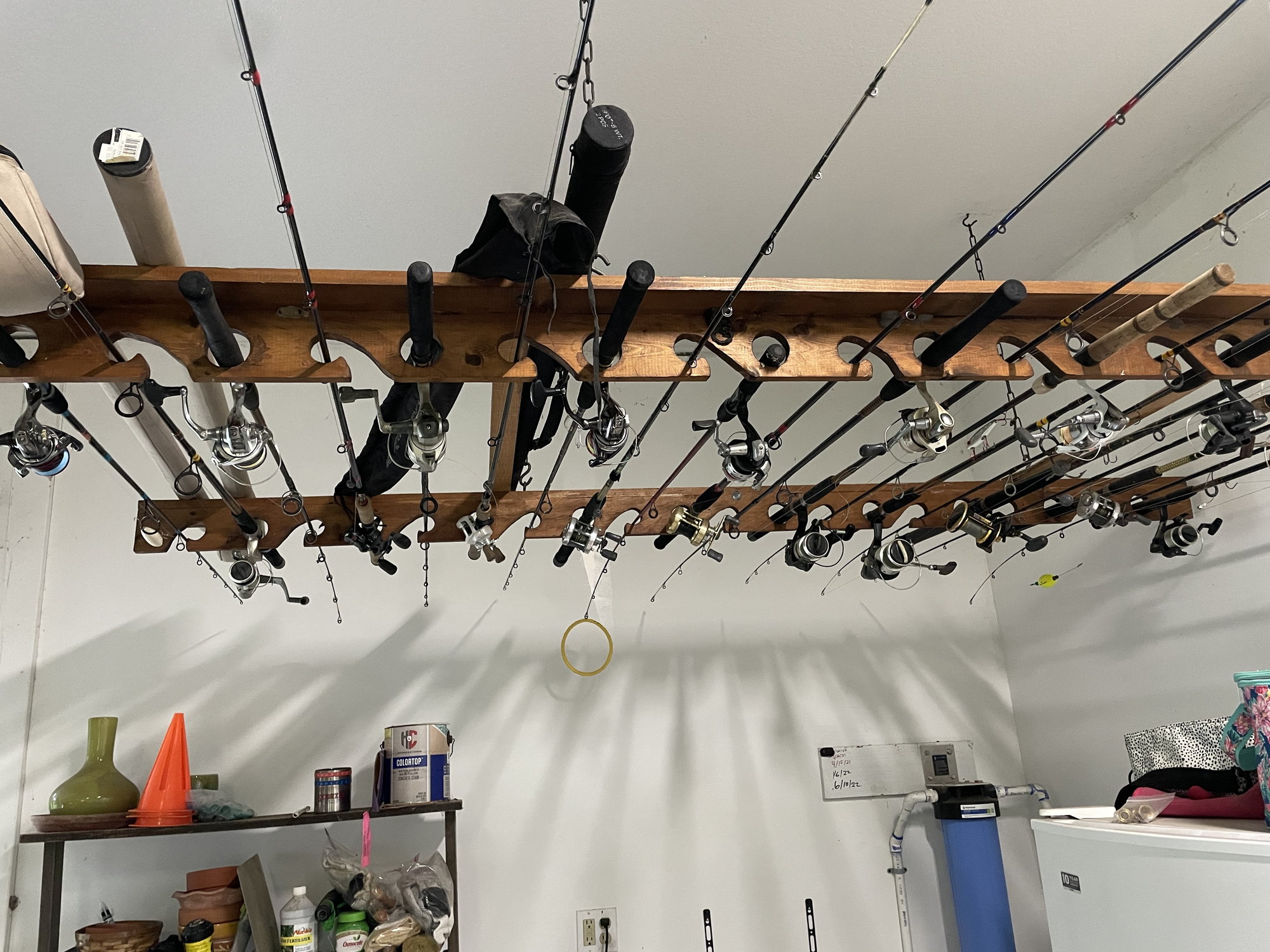 Fishing rod storage on the garage door. Rod holders screwed onto