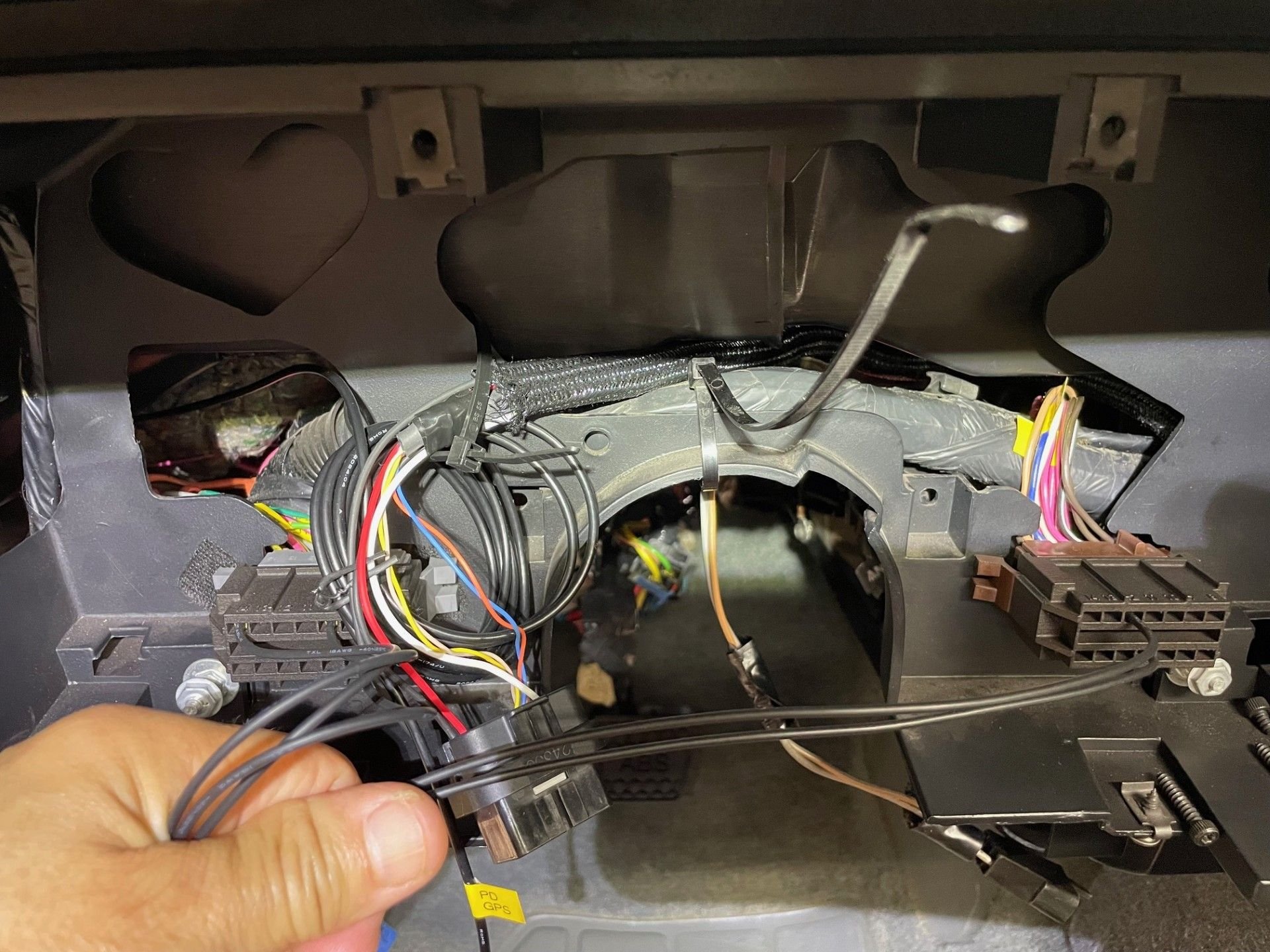 The ends of these wires will get Holley specific terminals crimped onto them and then inserted into the ProDash's connector seen just to the right of my thumb.