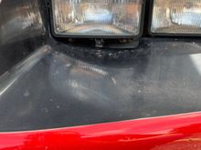 Driver side, gap underneath headlight