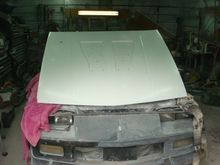 Setting atop the hinges at a 90 degree angle.